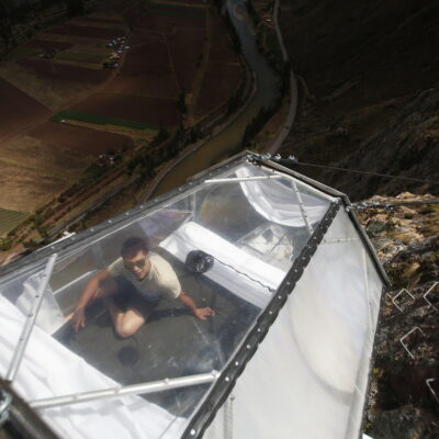 Tourists enjoy food inside a transparent cabine at the Skylodge Adventure Suites in the Sacred Valley in Cusco, Peru, August 14, 2015. The Skylodge is composed by three capsule suites hanging at the top of the 1200 ft mountain with a 300 degree view of the Valley. To sleep at Skylodge, people must climb 400 mt. of Via Ferrata path or hike a trail through ziplines. REUTERS/Pilar Olivares