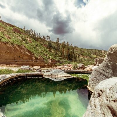 Pool of hot springs next to the rapids and mountains in the Colca Valley, Peru