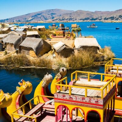 View of Uros floating islands with typical boats, Puno, Peru
