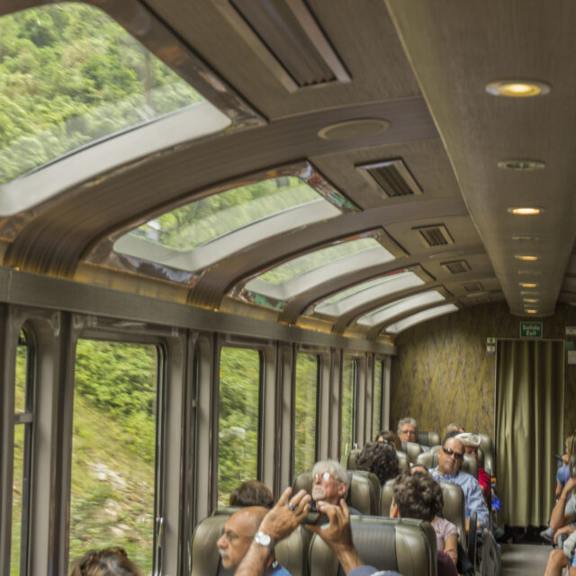 Tourist traveling in the panoramic Hiram Bingham train to Aguas Calientes in Perú. The town is the closest human settlement to the ancient Incan city of Machu Picchu and has become a tourist hub for visitors wishing to visit the famous Incan city.