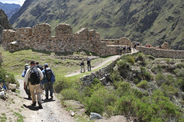 Cusco, Peru - November 14, 2010: Several hikers on the classic Inca Trail in Peru head toward the Incan ruins of Willkarakay.