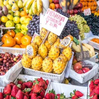 A little store in Mercado de Surquillo market selling the typical peruvian Pitahaya (Text translation: Pitahaya yellow and red)