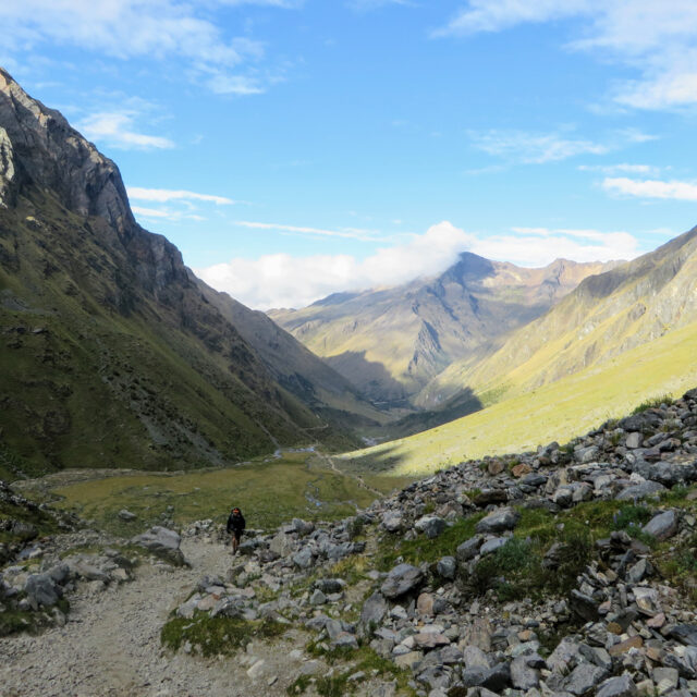 Cusco Province, Peru - May 8th, 2016: A young group of international hikers, led by their local Inca guide, navigate the Andes mountains on the Salkantay Trail towards Machu Picchu.