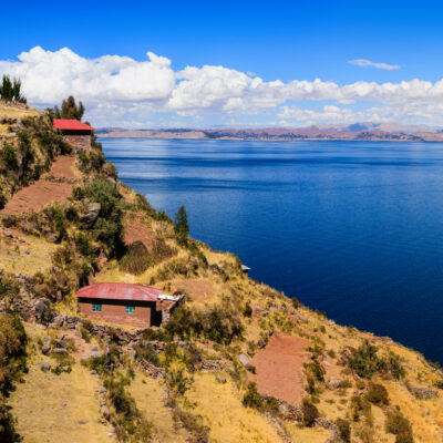 Lake Titicaca, view from Taquile Island, on background Peruvian shore. The lake is located at the northern end of the endorheic  Altiplano  basin high in the Andes on the border of Peru and Bolivia. The western part of the lake lies within the  Puno Region of Peru, and the eastern side is located in the Bolivian La Paz Department.The lake is composed of two  nearly separate sub-basins that are connected by the Strait of Tiquina which is 800 m (2,620 ft) across at the  narrowest point. The larger sub-basin, Lago Grande (also called Lago Chucuito) has a mean depth of 135 m (443 ft)  and a maximum depth of 284 m (932 ft). The smaller sub-basin, Winaymarka (also called Lago Pequeno, "little lake")  has a mean depth of 9 m (30 ft) and a maximum depth of 40 m (131 ft).The overall average depth of the lake is 107  m (351 ft)http://bhphoto.pl/IS/bolivia_380.jpg