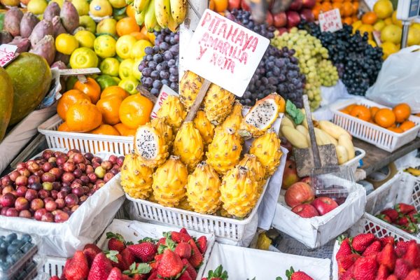 A little store in Mercado de Surquillo market selling the typical peruvian Pitahaya (Text translation: Pitahaya yellow and red)